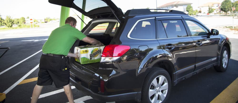 A Lyft driver loads goods into his car at a Walmart as part of the retailer's trial program to have Lyft and Uber drivers make deliveries.