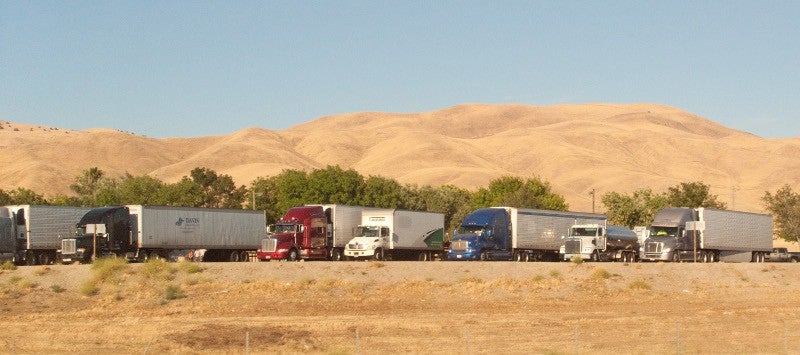 Trucks are parked at a rest stop along I-5 in California. Many spots for truckers to park do not include facilities, fuel locations or other amenities that make a 10-hour stay comfortable. (Photo: Wikimedia Commons/Downtown Gal)