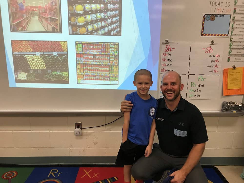  Cody Thacker and his son Greyson, who attended his father’s presentation on logistics. 