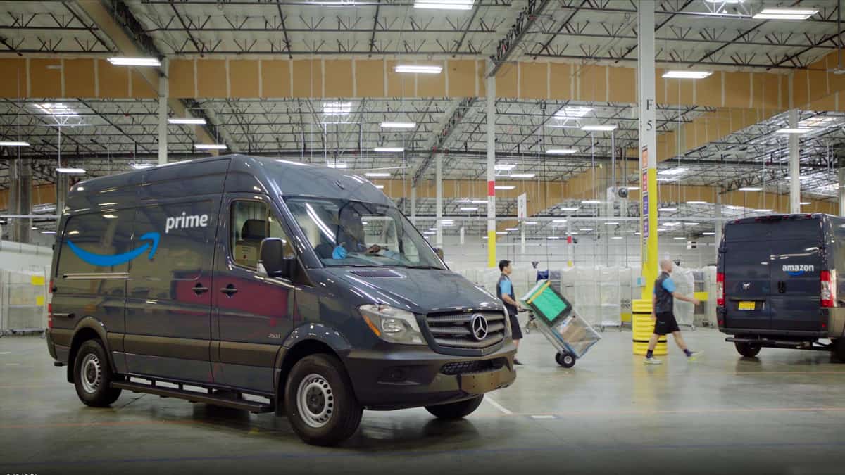 Amazon delivery van sits parked in a fulfillment center.