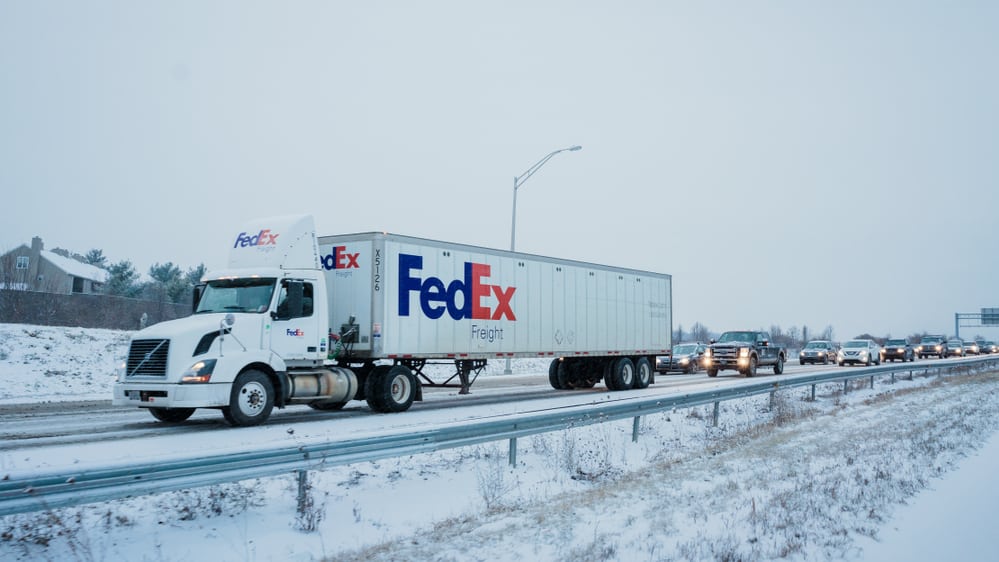 FedEx truck on snowy Pennsylvania highway.