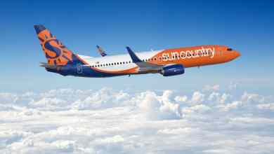 orange colored plane flying