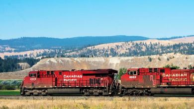 A photograph of a train with fields in the background.