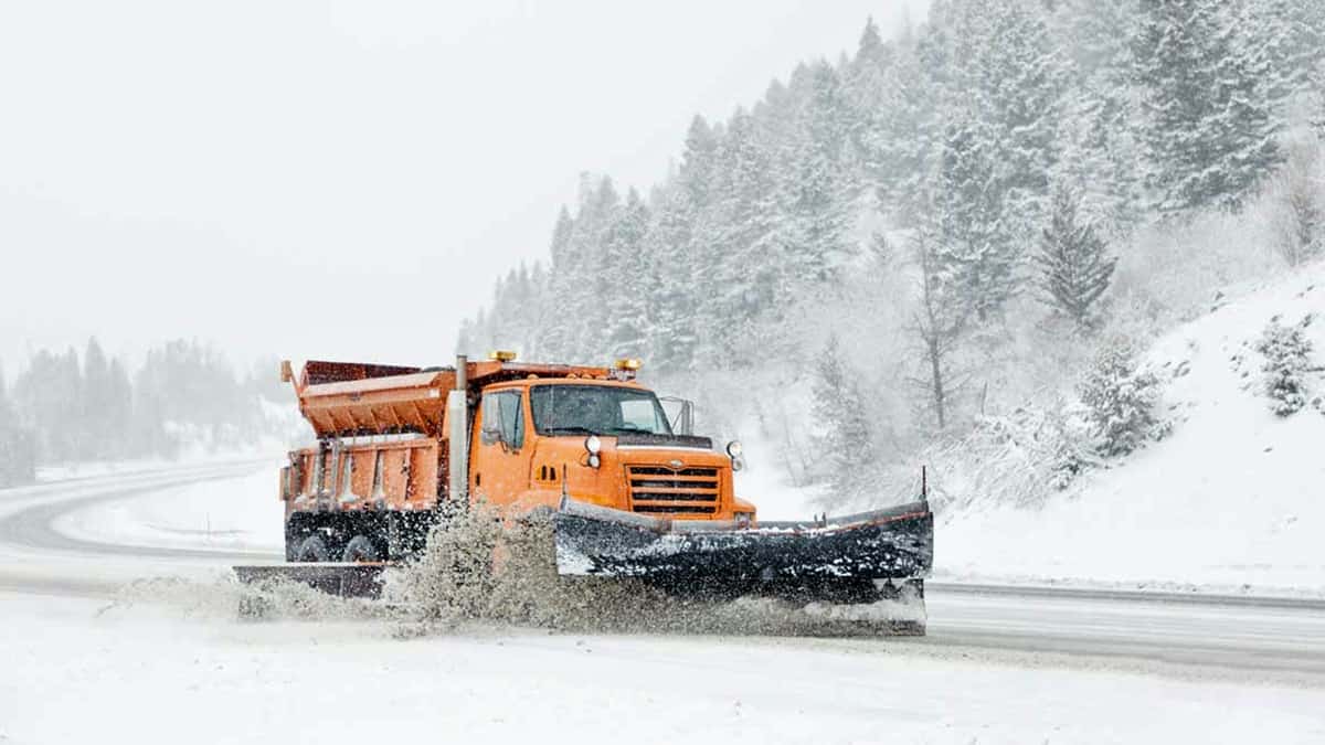 Snow plow on snowy mountain road in Montana.