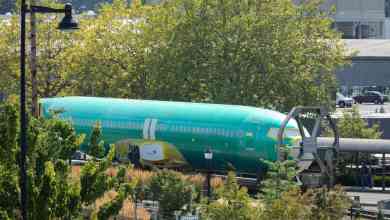 A 737 MAX fuselage waiting outside to enter factory.