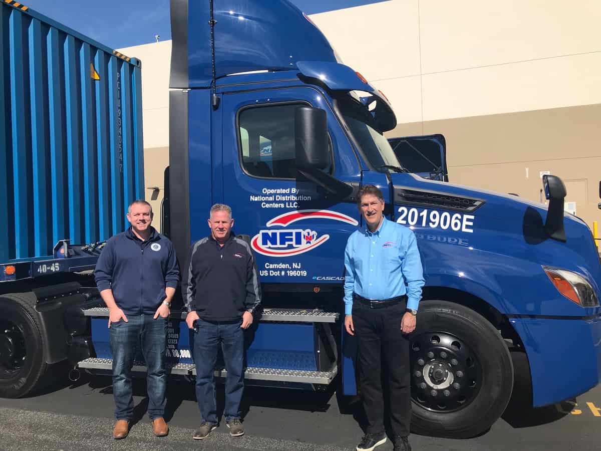 NFI executives with Freightliner eCascadia