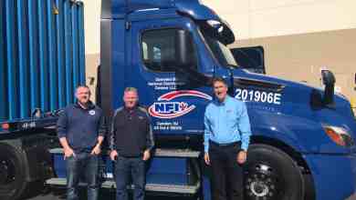 NFI executives with Freightliner eCascadia
