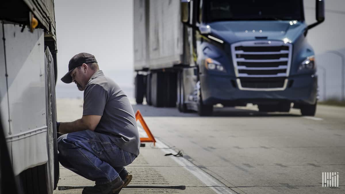 Worker repairing truck