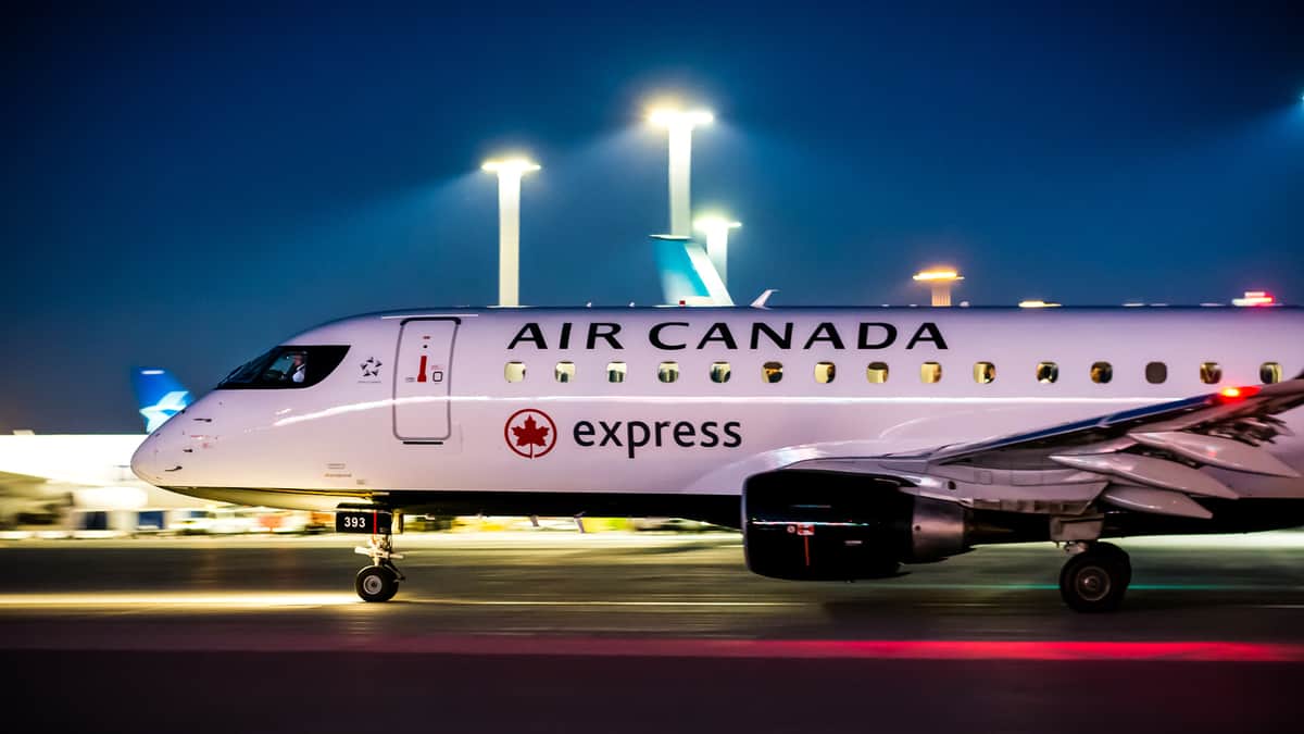 White Air Canada plane taxiing at night