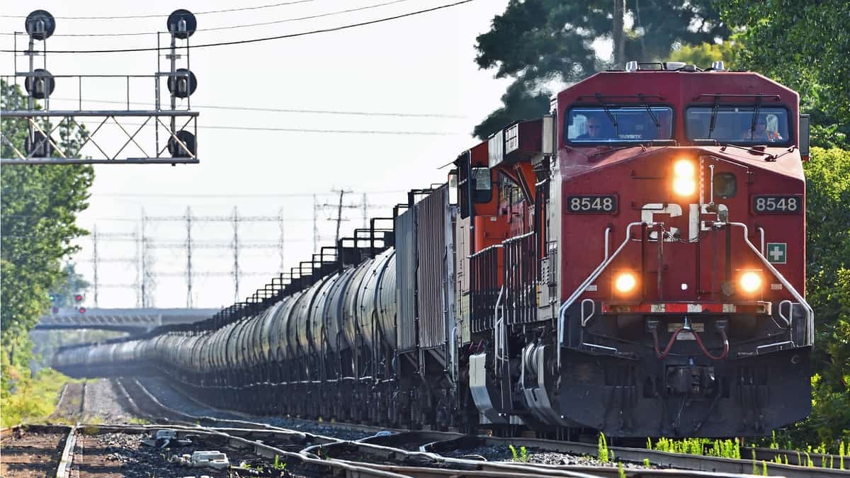 A photograph of a train near a crossing.