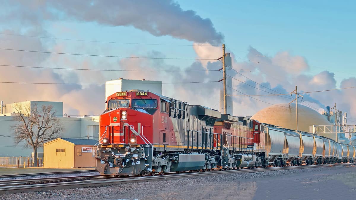 A photograph of a train. There are low clouds in the background.