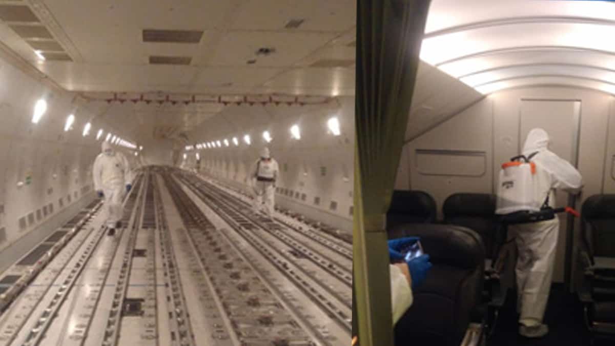 Disinfectant teams spray plane's cargo hold