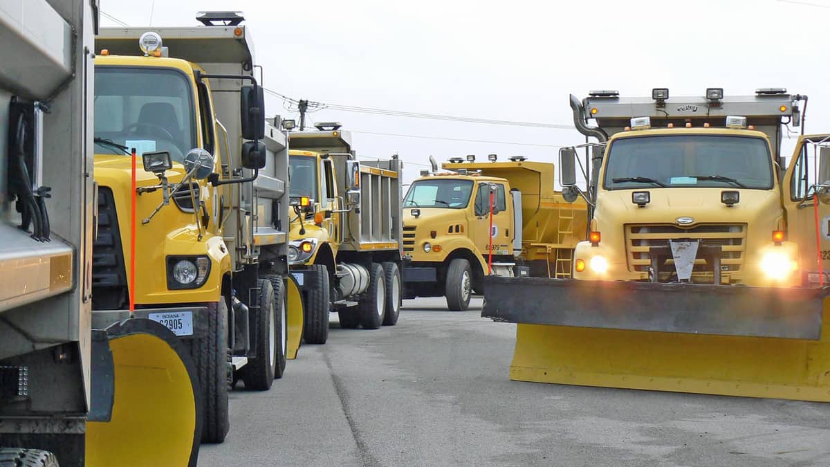 Plow trucks getting ready before an Indiana snowstorm.