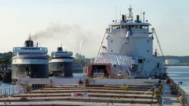 A photograph of three cargo vessels sailing in water.