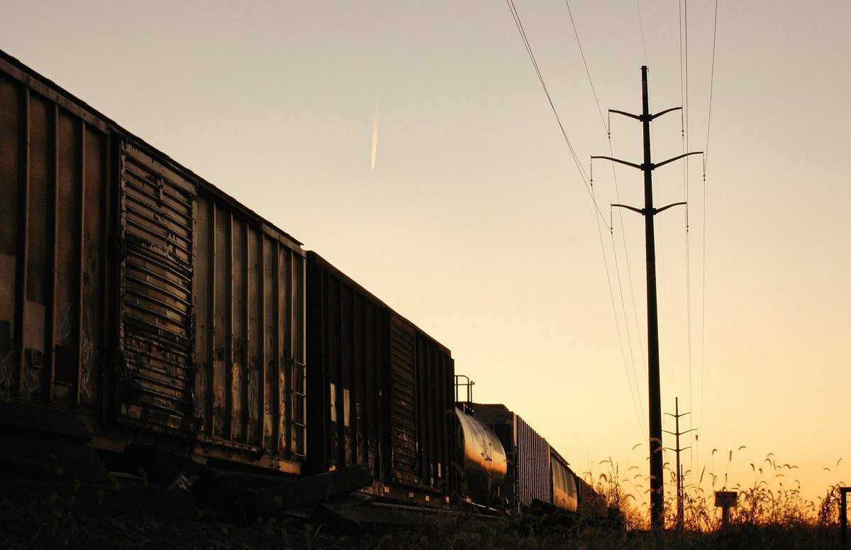 A photograph of railcars taken at dusk.