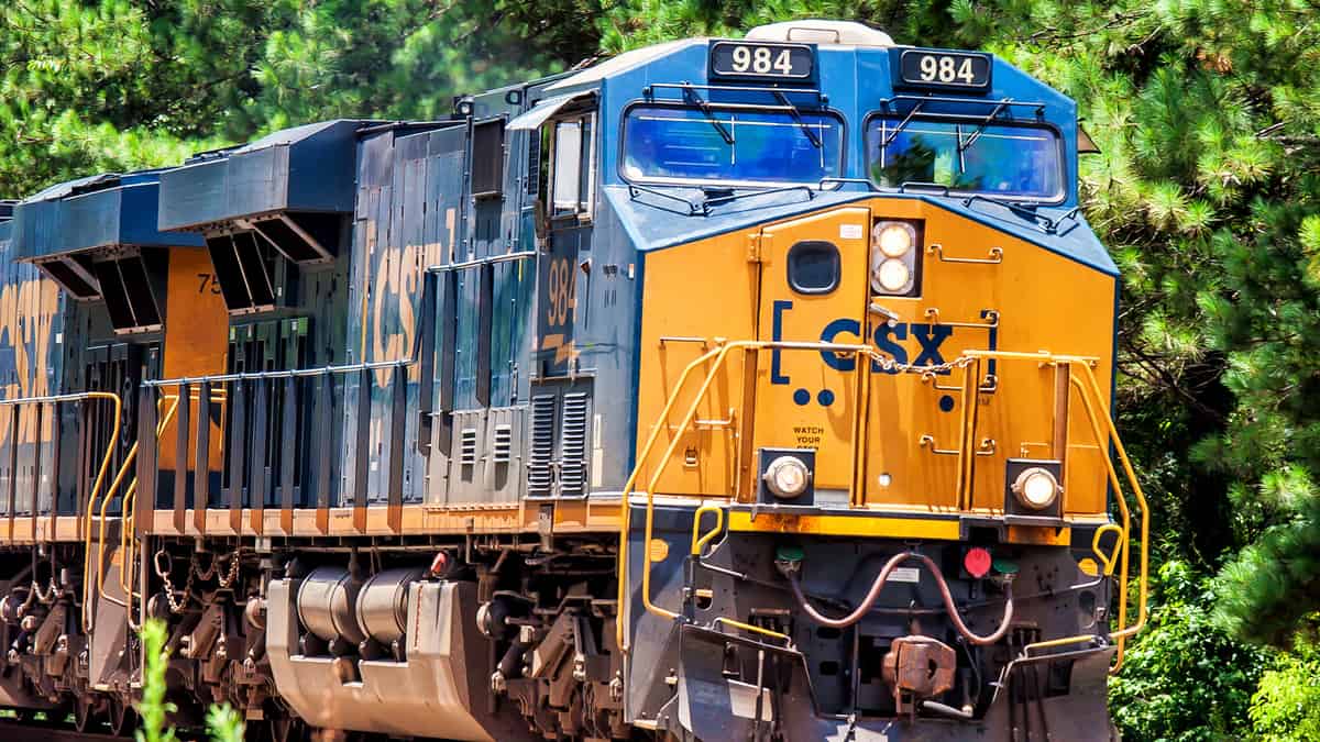 A photograph of a locomotive. There are trees behind it.