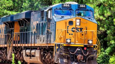 A photograph of a locomotive. There are trees behind it.