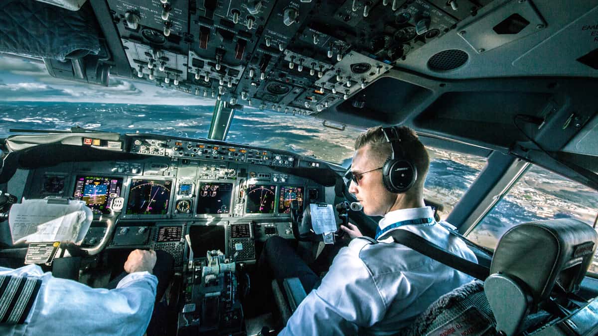 Pilots in cockpit flying at night