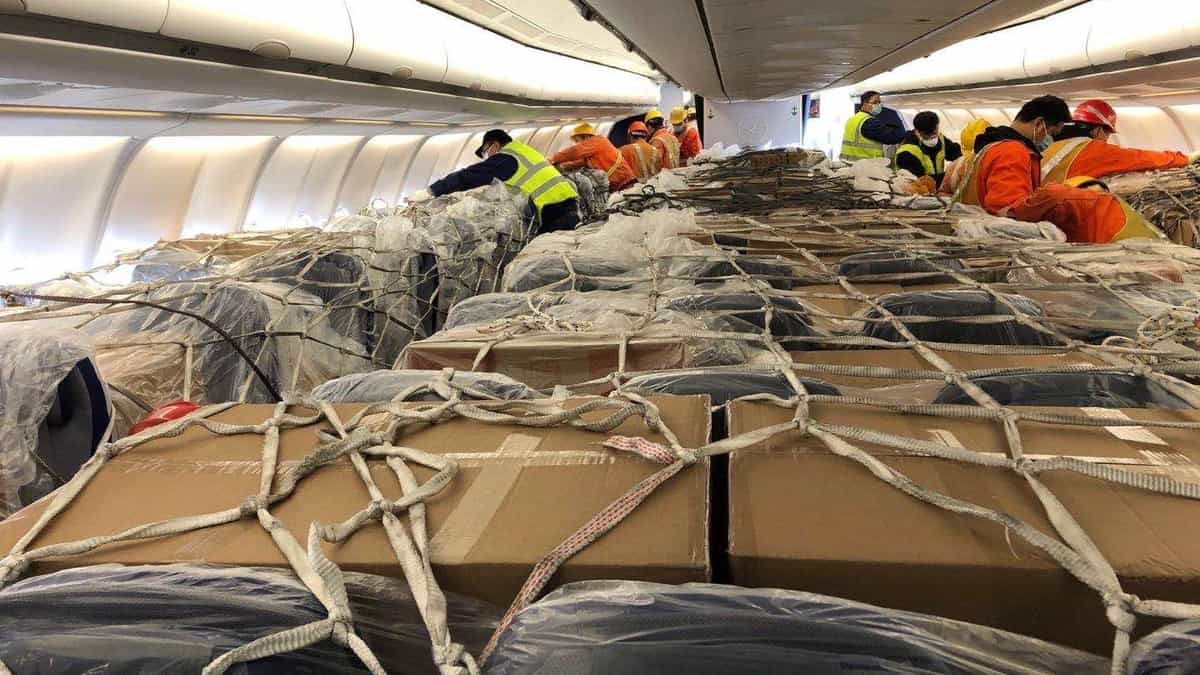 Workers put cargo in airplane seats