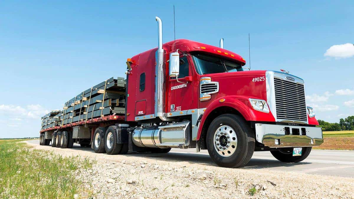 A tractor with a flatbed trailer of Mullen Group's Gardewine