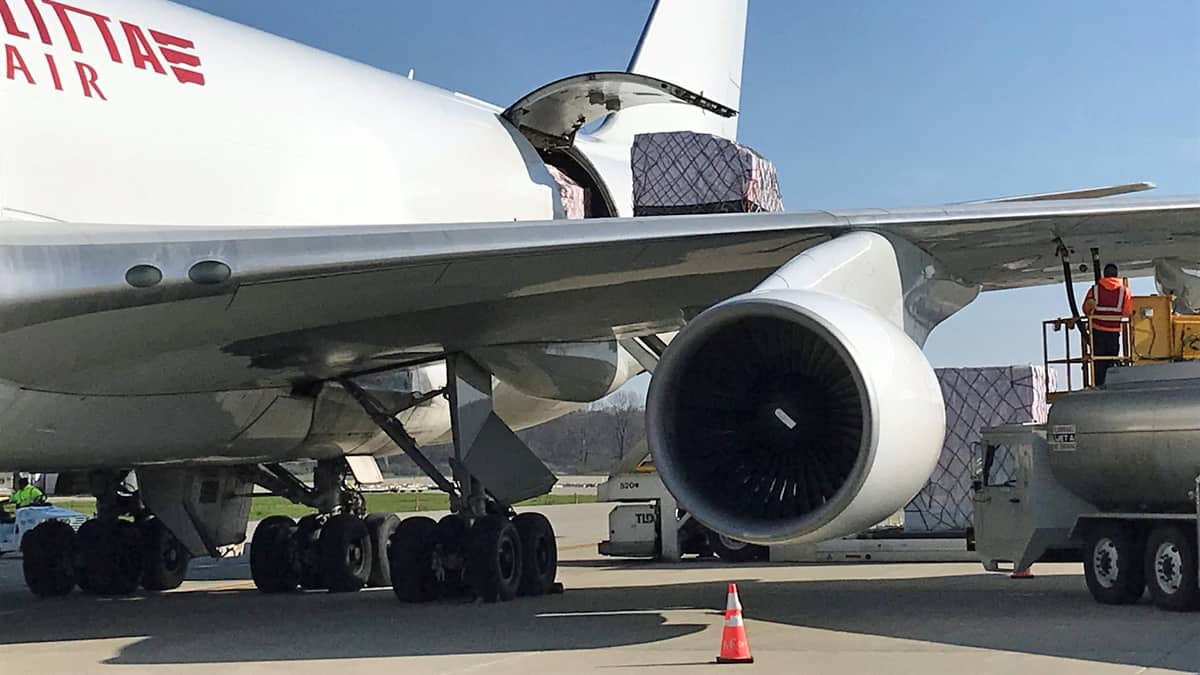 Close up of a white cargo plane being loaded.