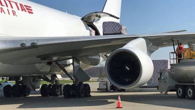 Close up of a white cargo plane being loaded.
