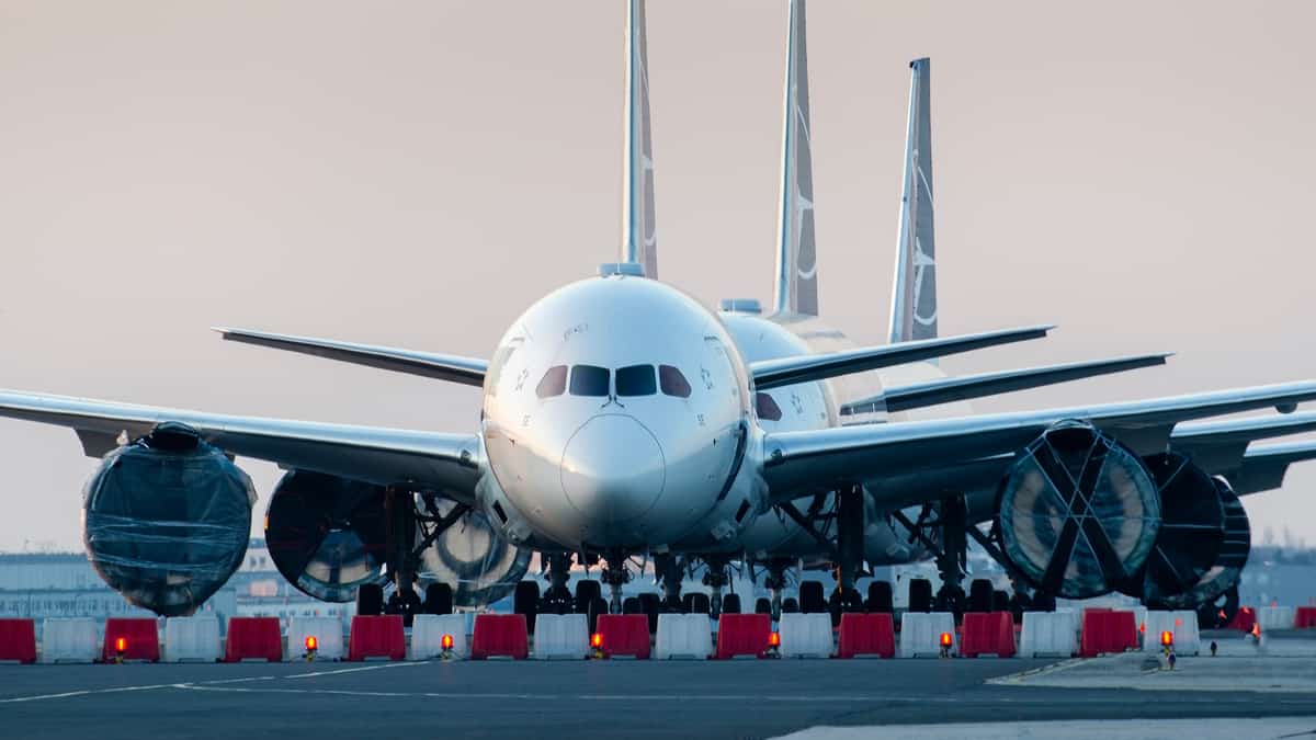 Line of planes pointed straight at camera on runway.