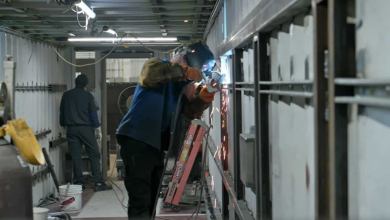 A welder inside a shipping container