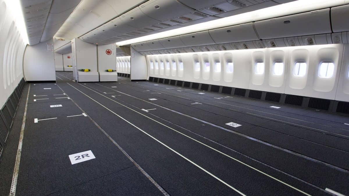 Passenger cabin of plane with seats removed for cargo.