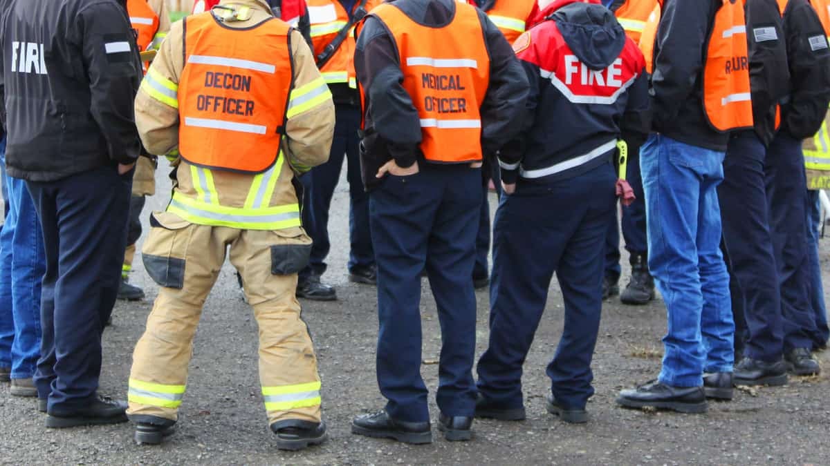 A photo showing the backs of many first responders.