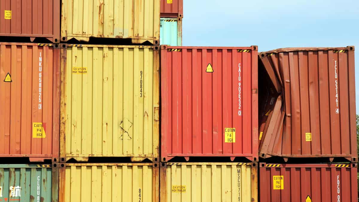 Several stacked containers; one is severely dented.