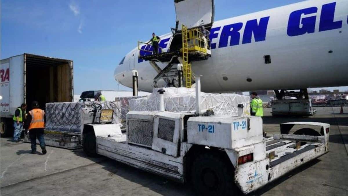 Cargo loaded onto a big white cargo plane.