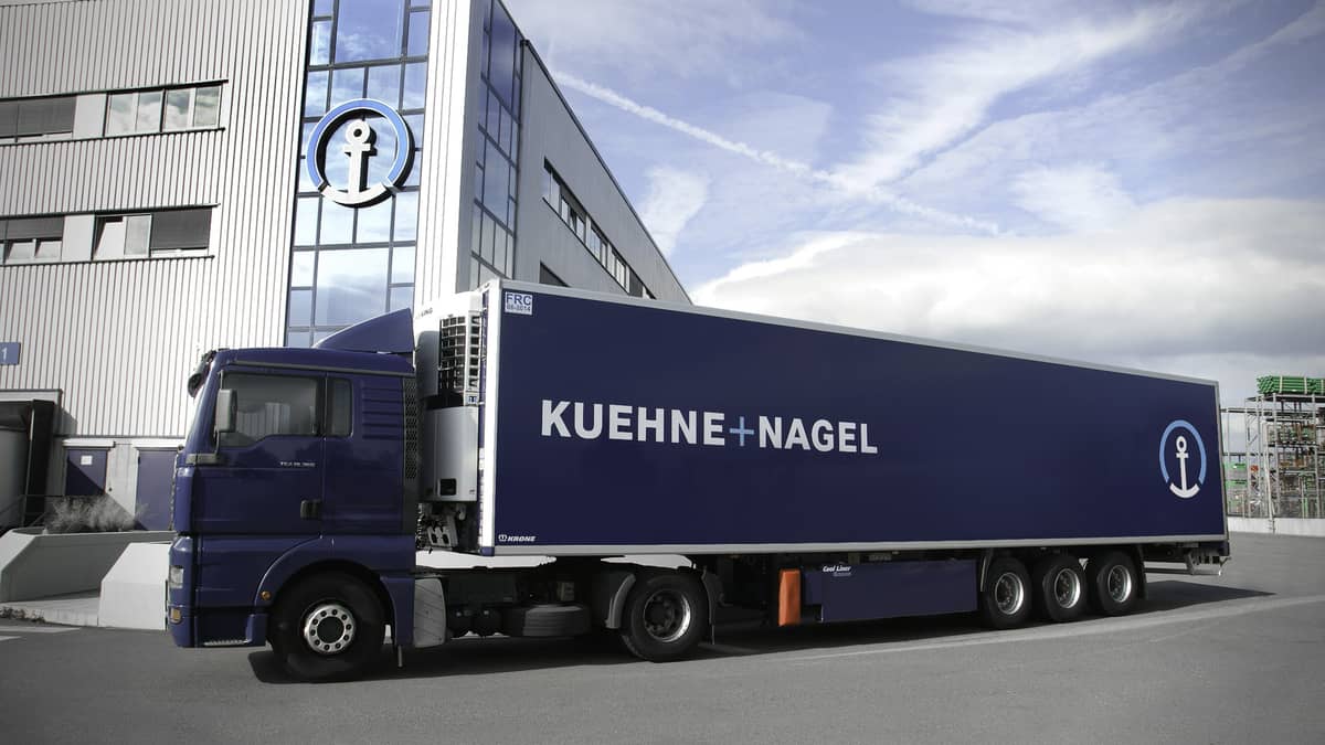 Kuehne + Nagel 18-wheeler in front of building.