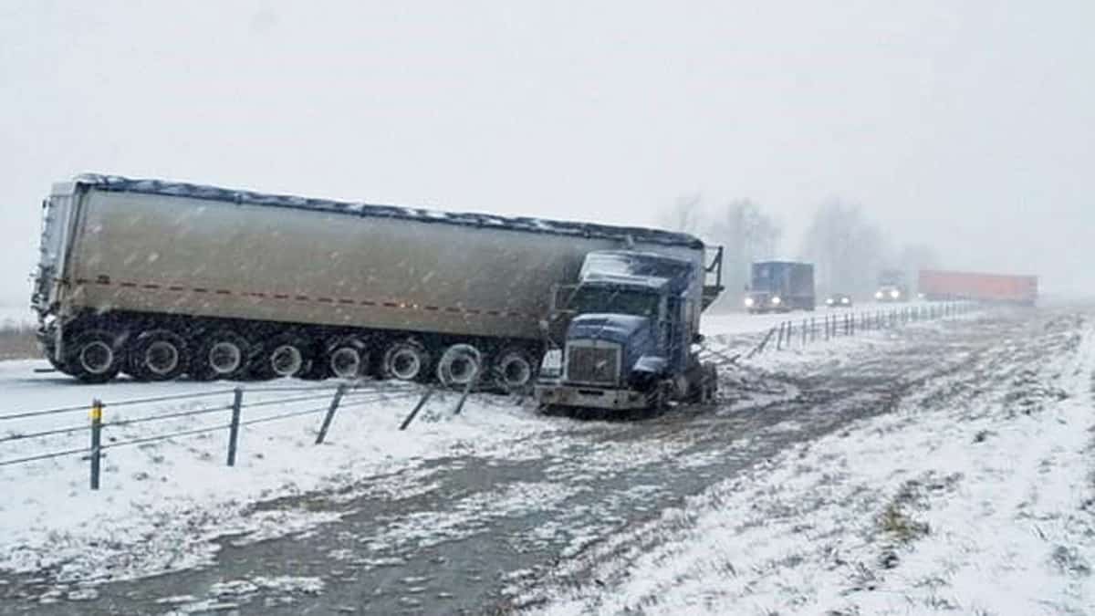 Tractor-trailer wrecks on snowy Michigan highway.