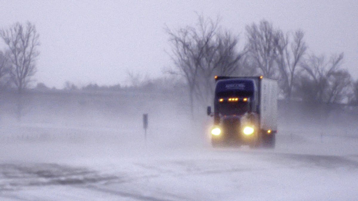 Tractor-trailer on snowy Minnesota highway.