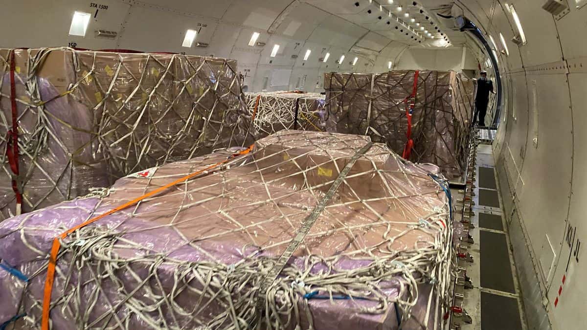 Pallets of freight inside a giant cargo plane.