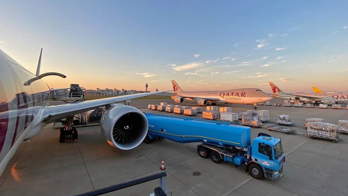 Cargo plane being loaded with beautiful sky in background.at