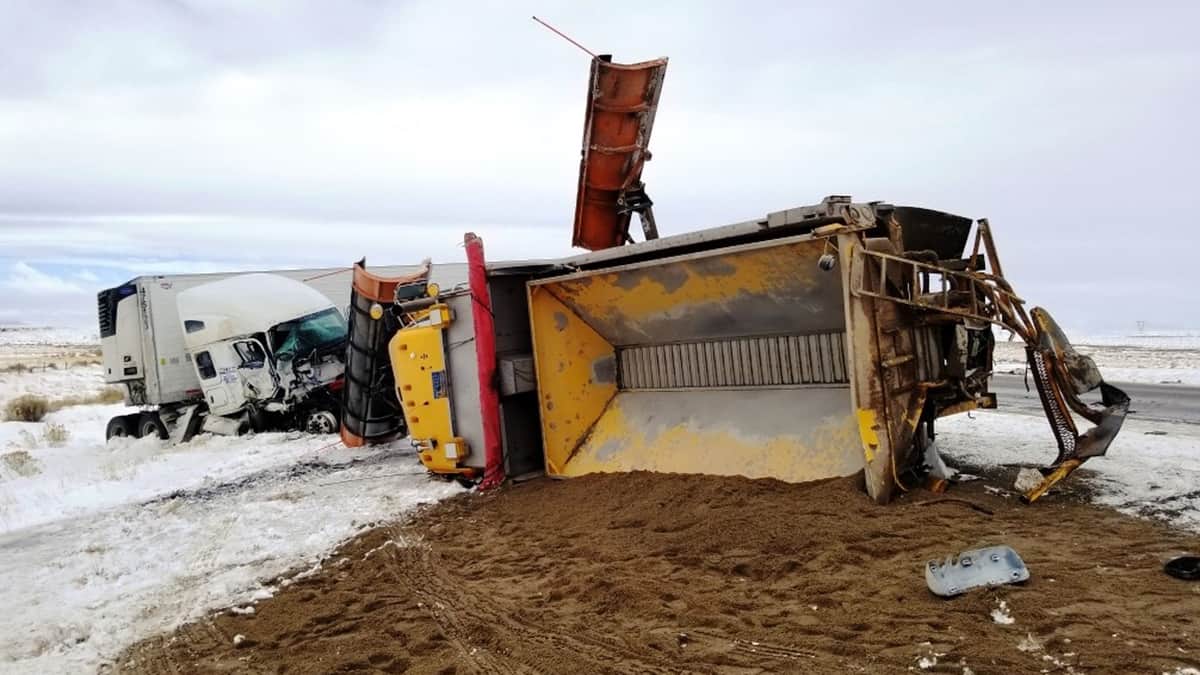 Overturned tractor-trailer on snowy Wyoming highway.on