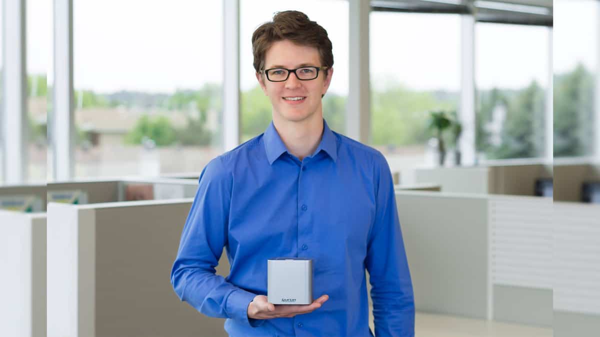 A man holding a Spartan Cube testing device.
