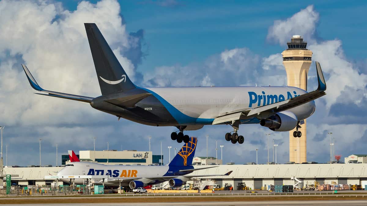 Amazon Prime Air plane comes in for landing at airport.