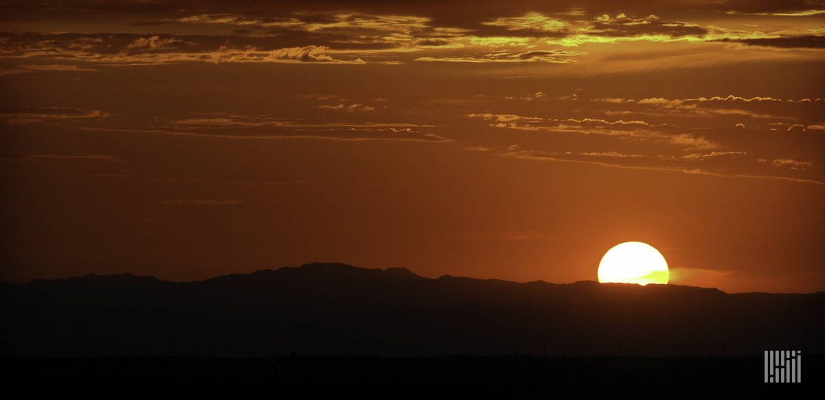 Sun just above the horizon of the Southwest desert sky.