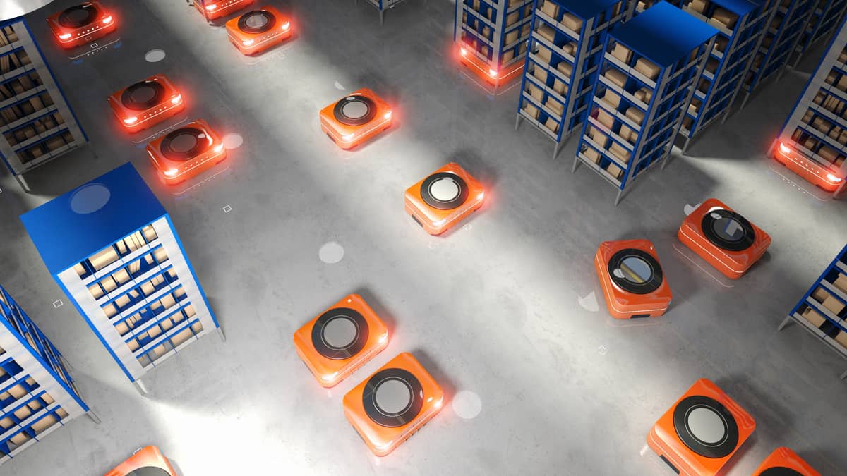 Robots move around in a warehouse space.