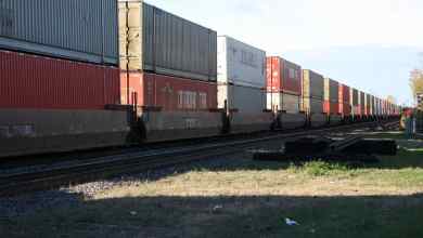 A photograph of intermodal containers on a passing train.