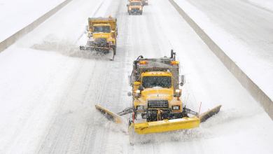 Plows clearing snowy Pennsylvania highway.
