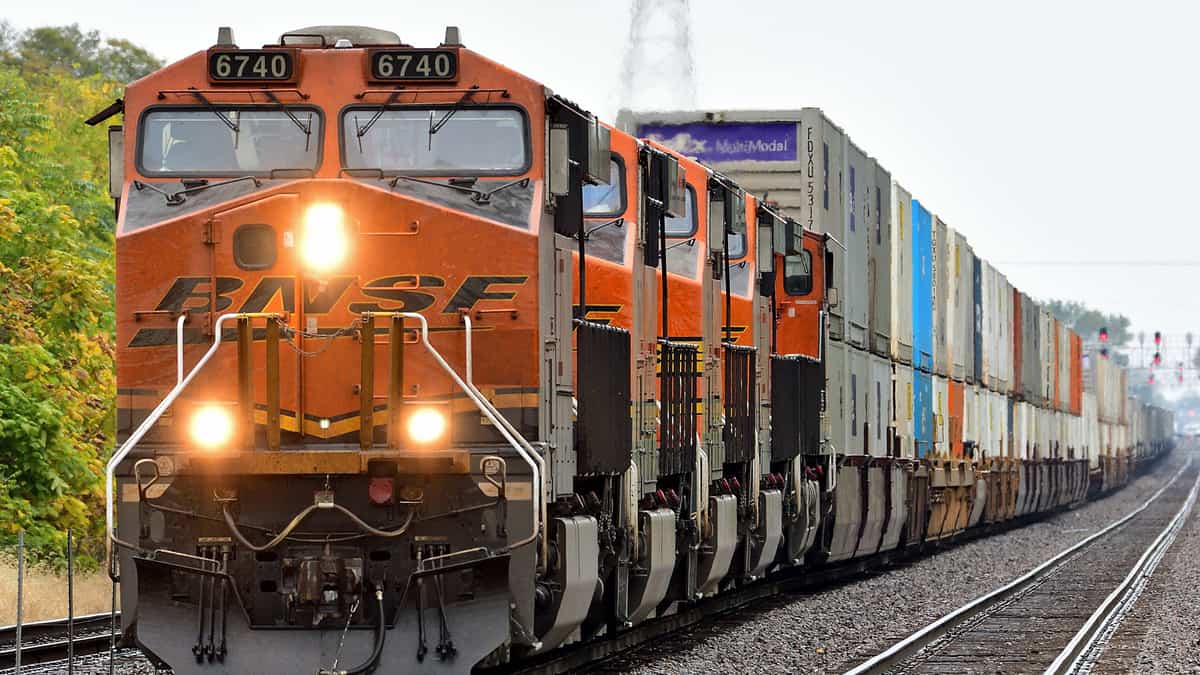 A photograph of a train locomotive pulling intermodal containers.