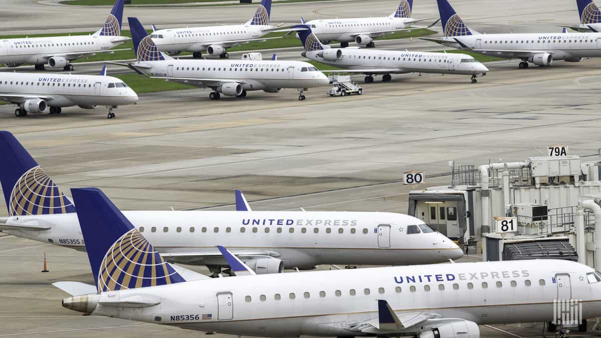 White regional jets parked at airport.