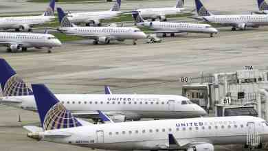 White regional jets parked at airport.