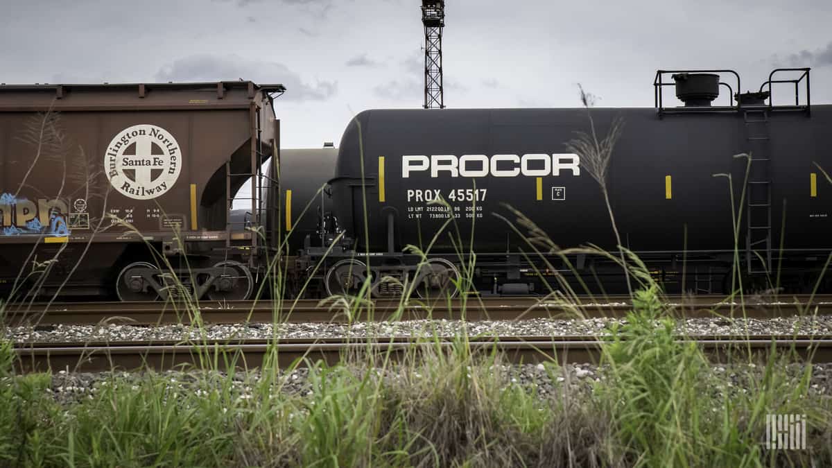 A photograph of a hopper car and a tank car.