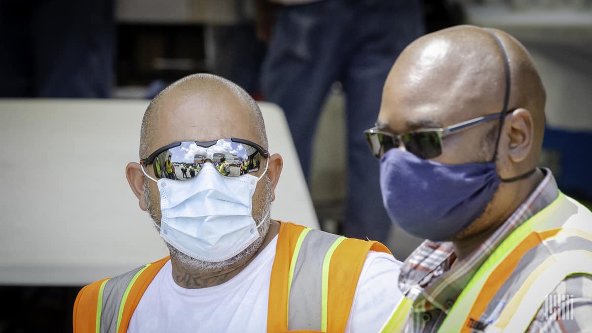 Truckers wearing protective masks.