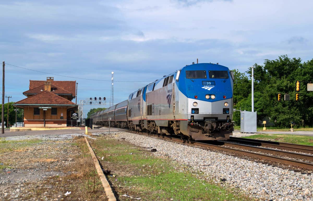 A photograph of a train leaving a train station.